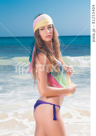 Attractive young woman on the beach enjoying near the sea in spring or summer Attractive young woman on the beach enjoying near the sea in spring or summer 81253404