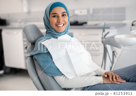 Happy Islamic Lady In Hijab Sitting In Chair At Dental Clinic Happy Islamic Lady In Hijab Sitting In Chair At Dental Clinic 81253911