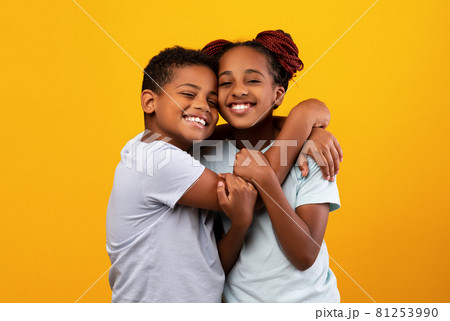 Loving black boy hugging his pretty sister 81253990