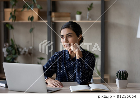 Pensive Indian woman work on laptop thinking Pensive Indian woman work on laptop thinking 81255054
