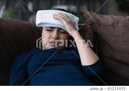 Unhealthy Indian woman relax suffering from migraine Unhealthy Indian woman relax suffering from migraine 81255055