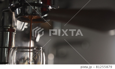 Low angle shot of pulling espresso with naked portafilter 81255879
