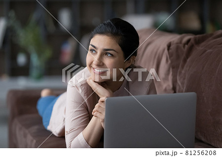Happy Indian woman distracted form computer work planning Happy Indian woman distracted form computer work planning 81256208