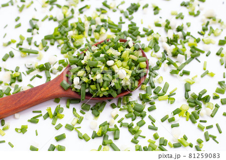 Chopped spring onions on white background Chopped spring onions on white background 81259083