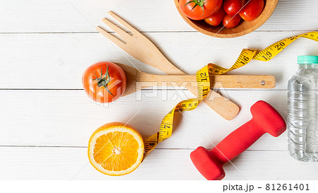 Diet Health eat and food for lifestyle health concept. Sport exercise equipment workout with fresh fruit and measuring tape for fitness style. 81261401