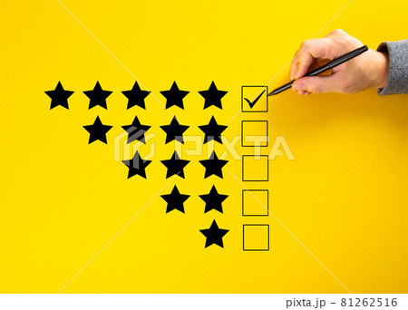 Hand putting a check on the 5 star rating. Hand putting a check on the 5 star rating. 81262516