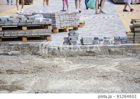 Process of construction of brick paved sidewalk, half built pavement road 81264632