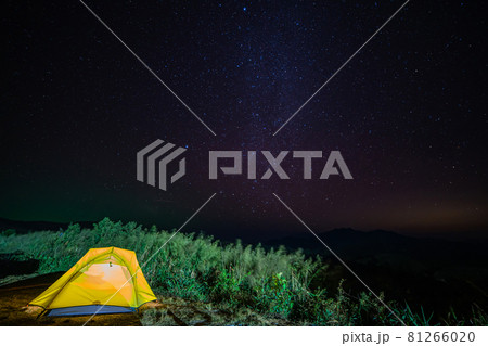 Tourist tent in camp among meadow with Panorama view universe space shot of milky way galaxy with stars on night sky background at mountains landscape Thailand Tourist tent in camp among meadow with Panorama view universe space shot of milky way galaxy with stars on night sky background at mountains landscape Thailand 81266020