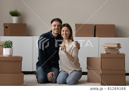 Young couple showing keys feel happy on moving day Young couple showing keys feel happy on moving day 81269168