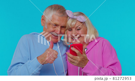 Happy senior couple man woman grandparents use mobile phone celebrating found out great big win news 81272953