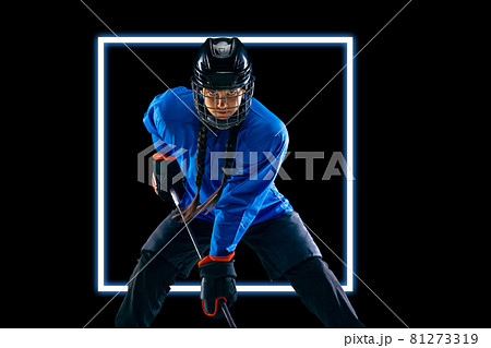 Abstract desing, concept of sport, action, motion in sport. Young sportsman, female hockey player in neon light on black background Abstract desing, concept of sport, action, motion in sport. Young sportsman, female hockey player in neon light on black background 81273319