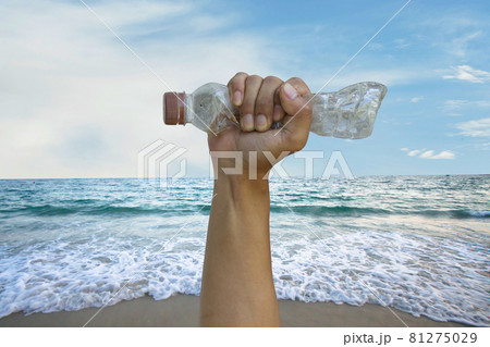 Hand of volunteer hold plastic bottle cleaning and protect beach from plastic pollution 81275029
