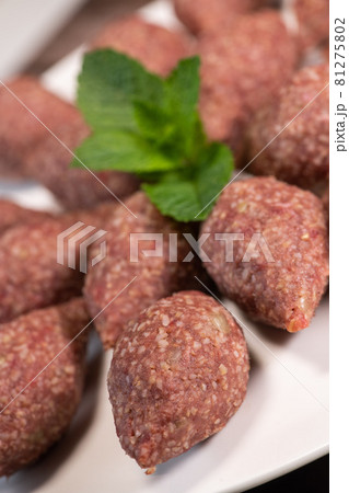 Traditional kebbe and pita bread on big round plate in lebanese restaurant Traditional kebbe and pita bread on big round plate in lebanese restaurant 81275802