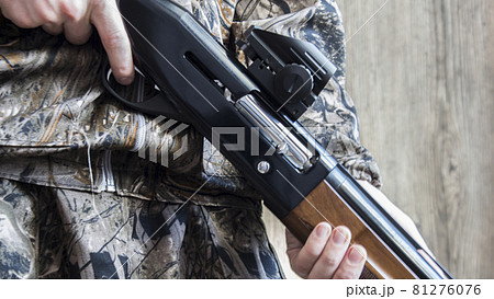 12-gauge rounds and a camo shotgun. 81276076