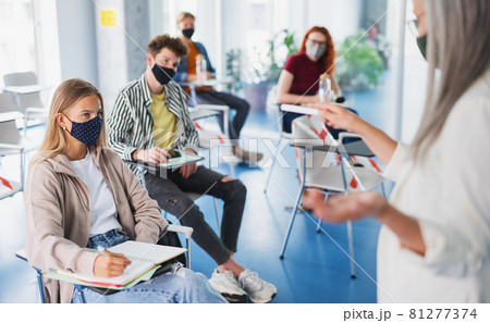 Portrait of university student in classroom indoors, coronavirus and back to normal concept. Portrait of university student in classroom indoors, coronavirus and back to normal concept. 81277374