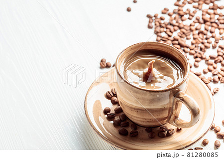 Latte and coffee beans on a white wooden table. Latte and coffee beans on a white wooden table. 81280085
