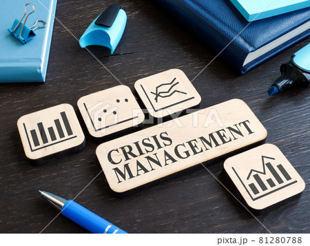 Crisis management on the wooden plate and plates with charts. 81280788