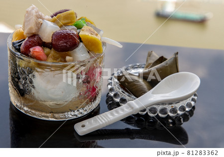 Traditional chinese iced sweet dessert is delicious here are many grains Topping with boil sugar syrup in Glass bowl. Traditional chinese iced sweet dessert is delicious here are many grains Topping with boil sugar syrup in Glass bowl. 81283362