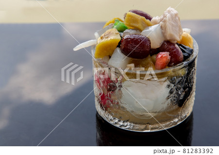 Traditional chinese iced sweet dessert is delicious here are many grains Topping with boil sugar syrup in Glass bowl. Traditional chinese iced sweet dessert is delicious here are many grains Topping with boil sugar syrup in Glass bowl. 81283392