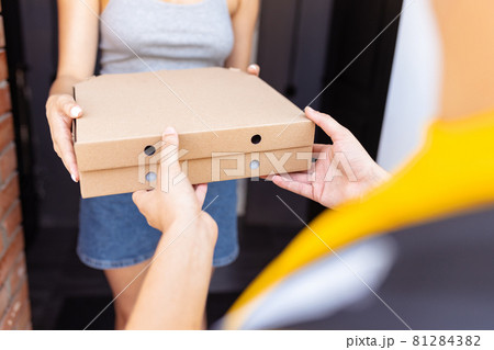 Close-up hands of deliveryman delivers order to clients, customers, buyers. Work, career, different professions concept. Idea of convenience, speed, comfort, safety, service. 81284382