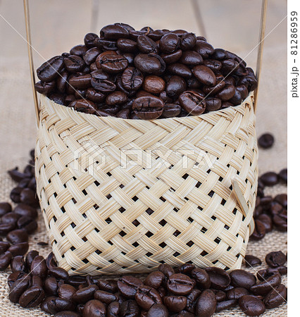 Coffee beans roasted in bamboo baskets. 81286959