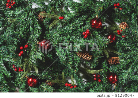 Full frame shot of Christmas tree branches and Xmas decorations. Top view. Fir tree, pine cones and Christmas baubles Full frame shot of Christmas tree branches and Xmas decorations. Top view. Fir tree, pine cones and Christmas baubles 81290047