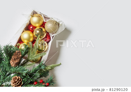 Branches of spruce tree with pine cones and Christmas toy decorations on white background. Top view. Copy space Branches of spruce tree with pine cones and Christmas toy decorations on white background. Top view. Copy space 81290120