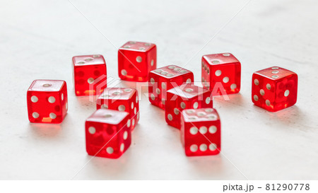 Ten red translucent craps dices on white board showing different numbers. Ten red translucent craps dices on white board showing different numbers. 81290778
