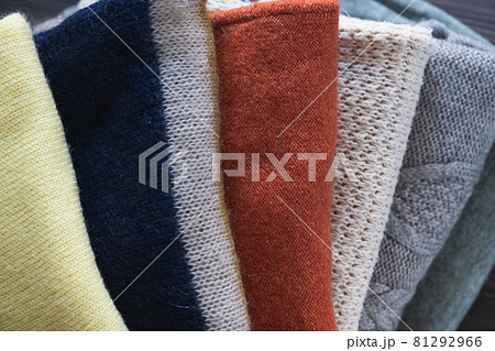 Knitted woolen clothes on wooden table close-up. Autumn or winter background. Knitted woolen clothes on wooden table close-up. Autumn or winter background. 81292966