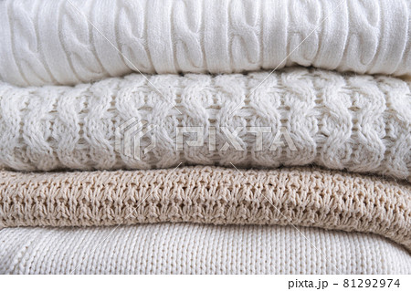 Warm cozy clothes with different knitted patterns close-up. Autumn or winter background. Warm cozy clothes with different knitted patterns close-up. Autumn or winter background. 81292974