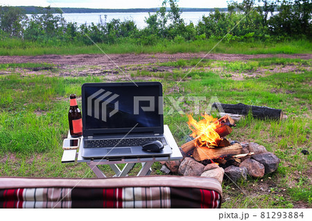 Camping with a lake, laptop, beer, and chair in the photo 81293884