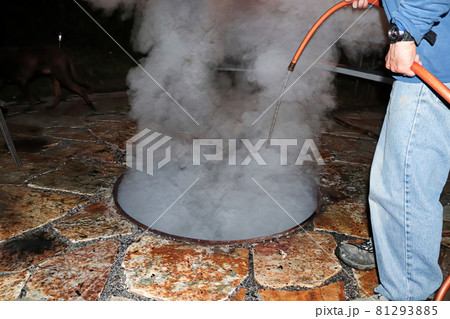 Putting out a campfire with water at the end of the night 81293885