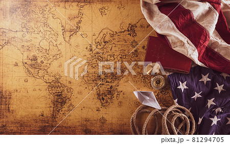 Happy Columbus Day concept. Vintage American flag, compass, paper boat, rope on retro treasure manuscript.  Flat lay, top view with copy space. 81294705