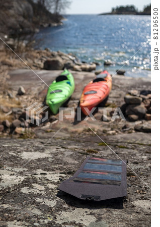 Portable solar panels lie on the stony shore of accumulating energy, against the background of the Portable solar panels lie on the stony shore of accumulating energy, against the background of the 81296500