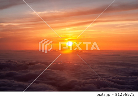 Airplane view of a gorgeous orange sunset above dark clouds, amazing sky. 81296975