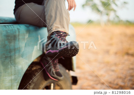 Traveller female sitting on car at nature,Hiking shoes woman in beautiful view,Road trip 81298016