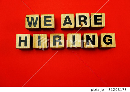 We are Hiring word created with cubes alphabet letters on red background 81298173