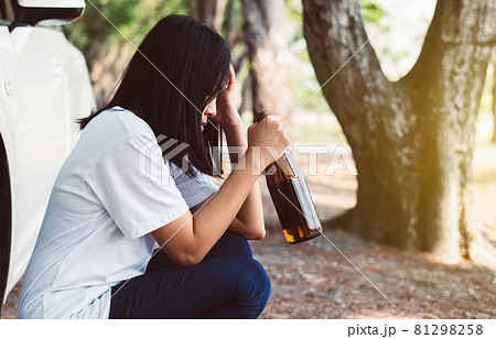 Drunk woman drinking alcohol while driving car on road,Women drive her car with a bottle of beer,Dangerous driving concept 81298258