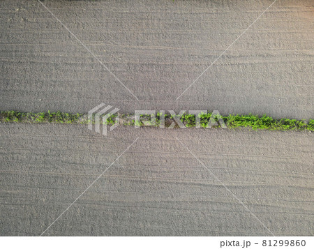 Aerial view field nature agricultural farm background, top view plowed field from above agricultural parcels of different furrows row pattern in a plowed field prepared for planting crops farmland Aerial view field nature agricultural farm background, top view plowed field from above agricultural parcels of different furrows row pattern in a plowed field prepared for planting crops farmland 81299860