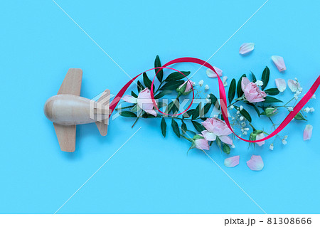 Travel concept with plane and flowers, petals on blue background. Top view, flat lay. Copy space. Trip, vacation concept. 81308666
