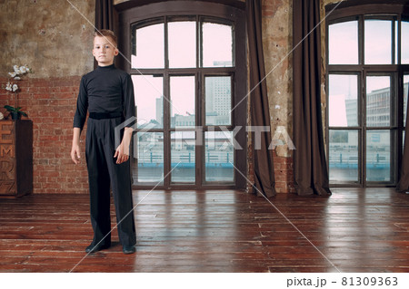 Young boy dancer staying against big window before dancing Young boy dancer staying against big window before dancing 81309363