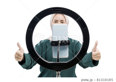 Asian Muslim woman with mobile phones and lighting equipment make a vlog Asian Muslim woman with mobile phones and lighting equipment make a vlog 81310165