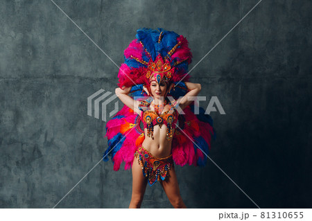 Woman in brazilian samba carnival costume with colorful feathers