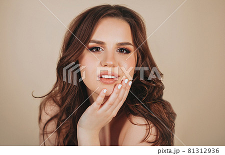 Happy woman smiling and touching her face 81312936