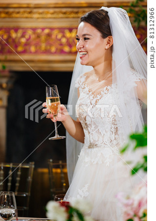 beautiful and happy bride with a glass of champagne. beautiful and happy bride with a glass of champagne. 81312966