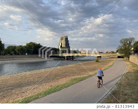 man on bicycle riding river embankment 81313943