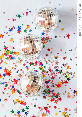 Disco ball on blue background with multicolored stars confetti Disco ball on blue background with multicolored stars confetti 81315738