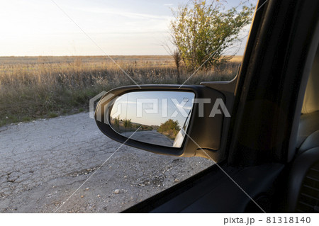 Looking in the side rear-view mirror in the day of dreams Looking in the side rear-view mirror in the day of dreams 81318140