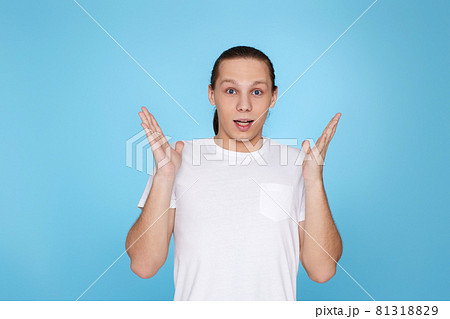 upset young guy in t-shirt isolated on blue background. 81318829