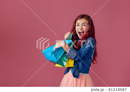 little caucasian child girl holds shopping bags 81319087